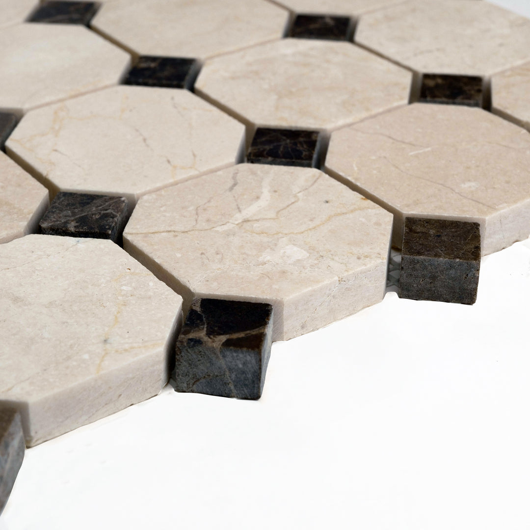 Polished 2 inch octagon Crema Marfil mosaic with brown dot detail, angled to emphasize the high-gloss finish and rich visual contrast.