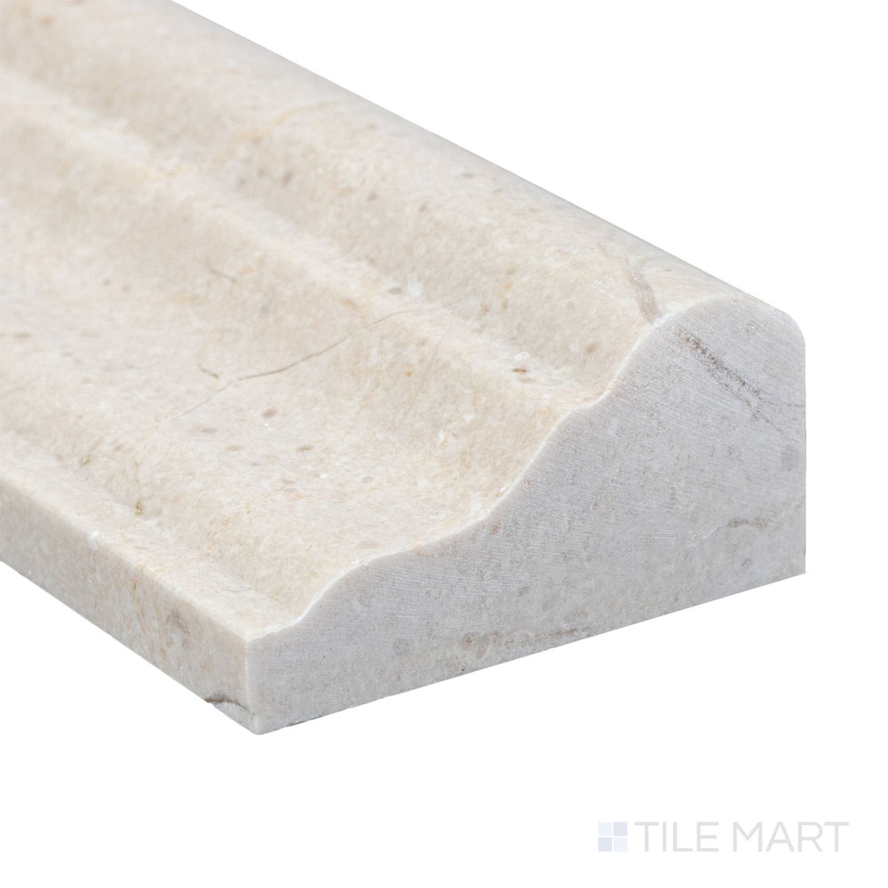 A refined corner view of Crema Marfil Marble 2x12 honed grand chair rail showing its soft matte texture and warm beige tone.