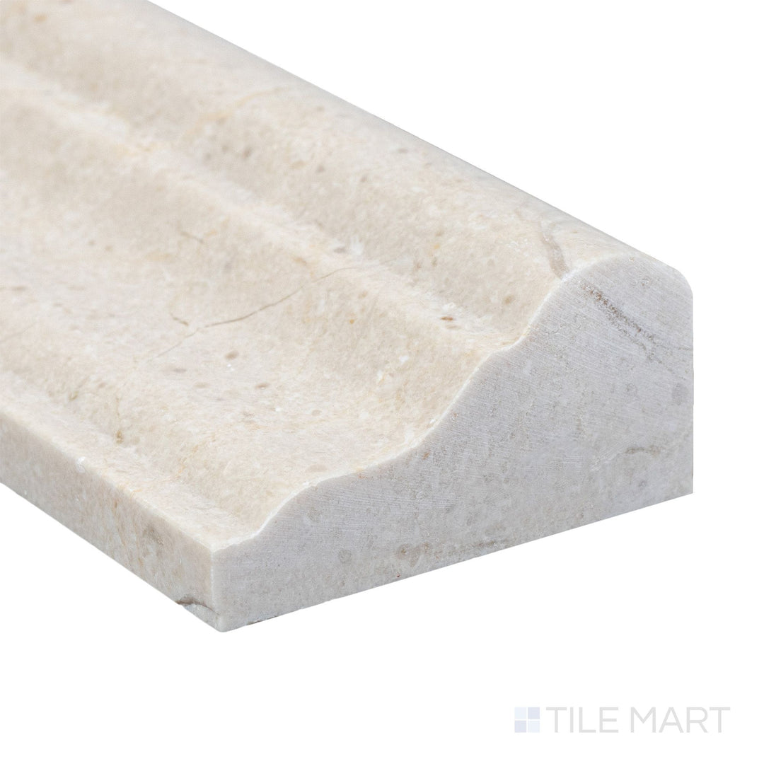 A refined corner view of Crema Marfil Marble 2x12 honed grand chair rail showing its soft matte texture and warm beige tone.