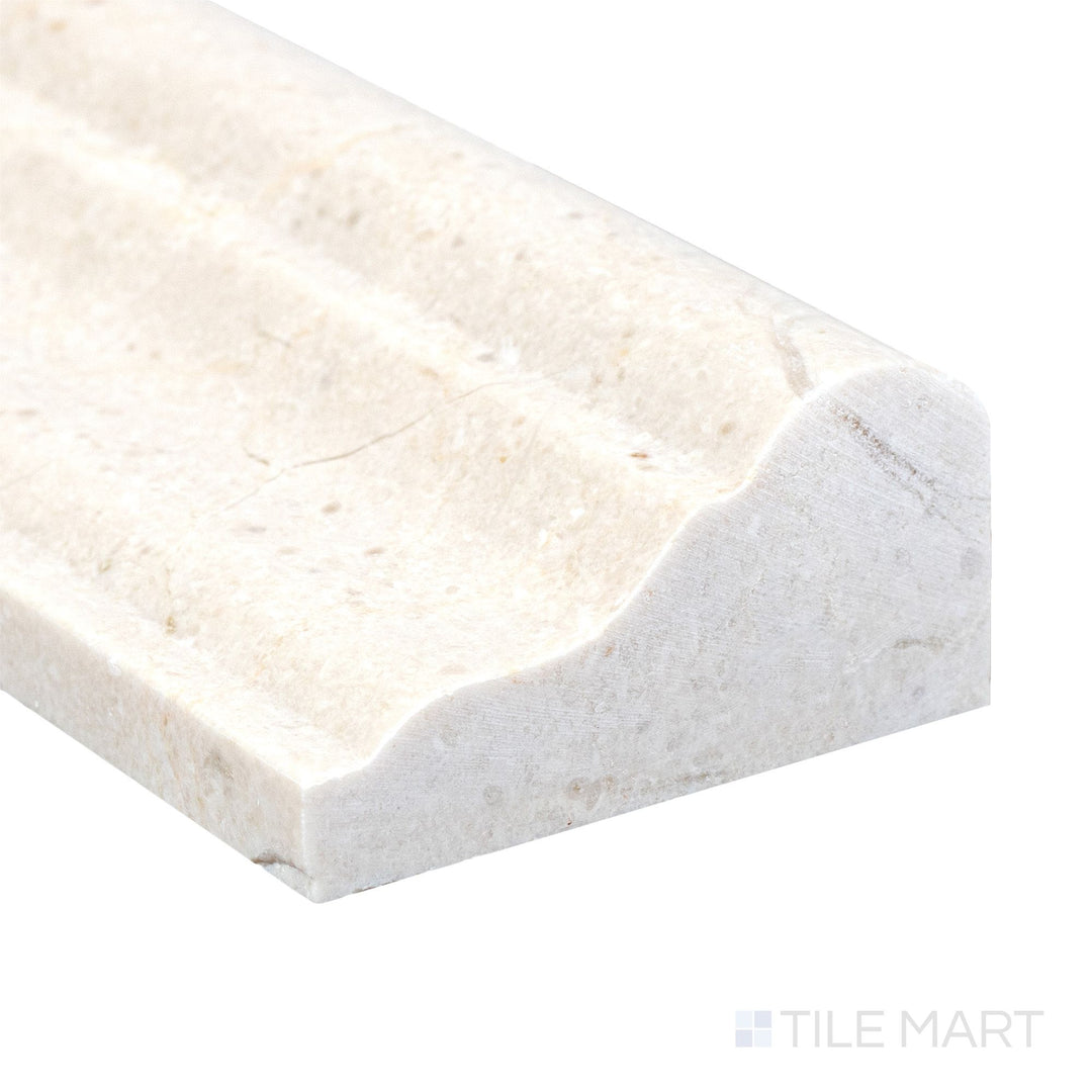 Polished to a high sheen, the Crema Marfil Marble 2x12 grand chair rail corner reveals elegant veining and a smooth finish.