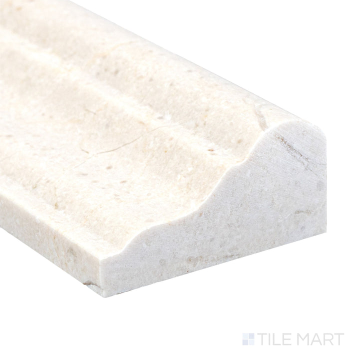 Polished to a high sheen, the Crema Marfil Marble 2x12 grand chair rail corner reveals elegant veining and a smooth finish.