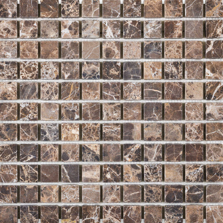 The Emperador Dark Marble 1" Square Tumbled Mosaic presents a rustic, aged appearance through its tumbled finish and earthy tone palette.