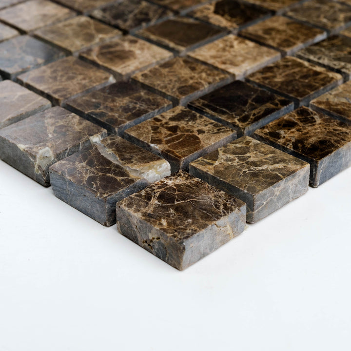 Tumbled 1 inch square Emperador Dark marble mosaic captured at a corner view, featuring softened edges and a warm, rustic texture.