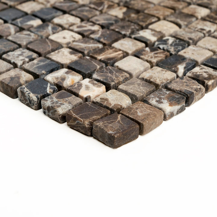5/8 inch square Emperador Dark marble mosaic with a tumbled finish, shown from the side to emphasize its miniature format and rustic charm.