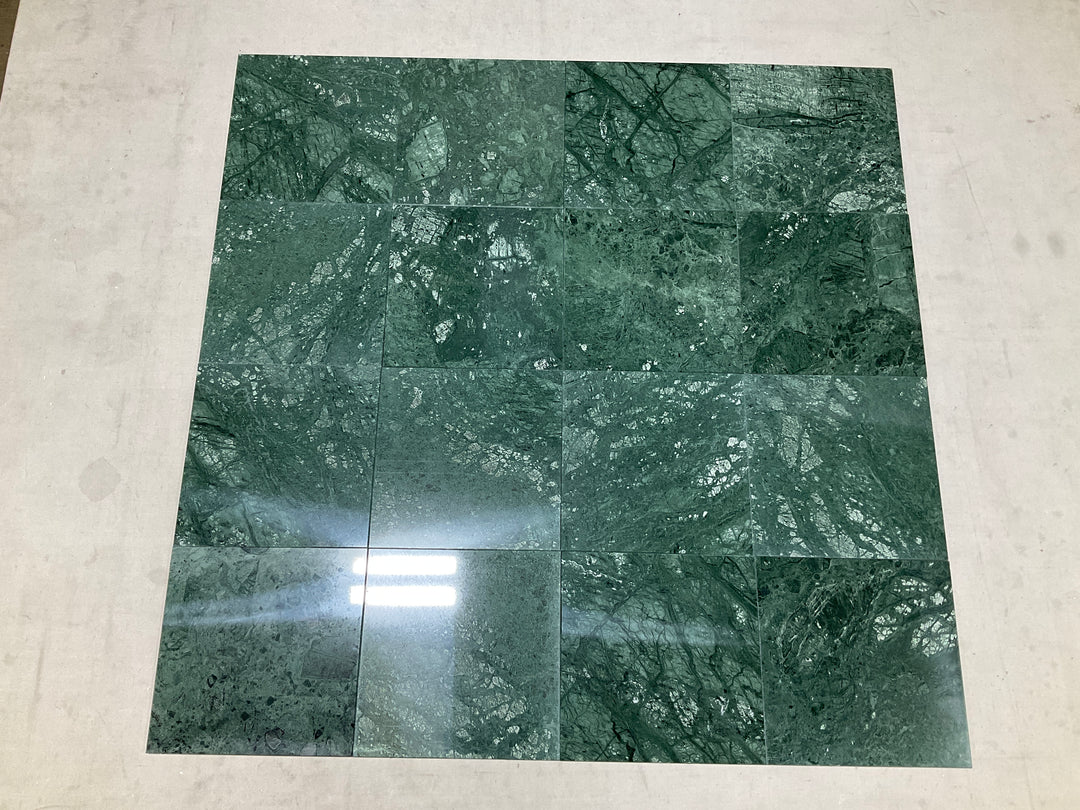 Multiple Empress Green 12x12 polished marble tiles assembled together showcasing their deep green tone and dramatic natural veining with a high-gloss finish