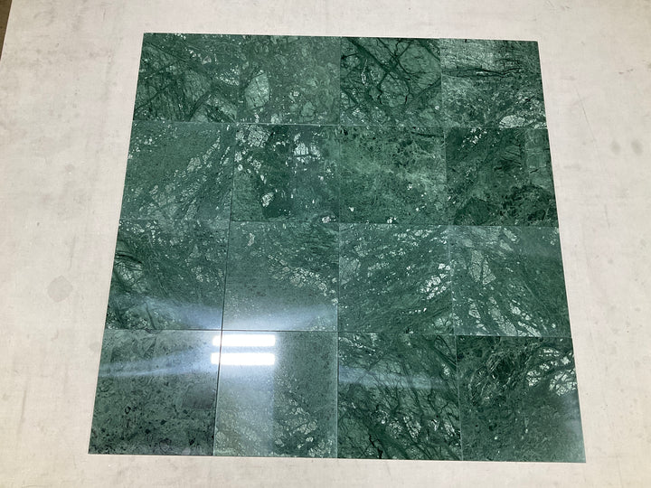 Multiple Empress Green 12x12 polished marble tiles assembled together showcasing their deep green tone and dramatic natural veining with a high-gloss finish
