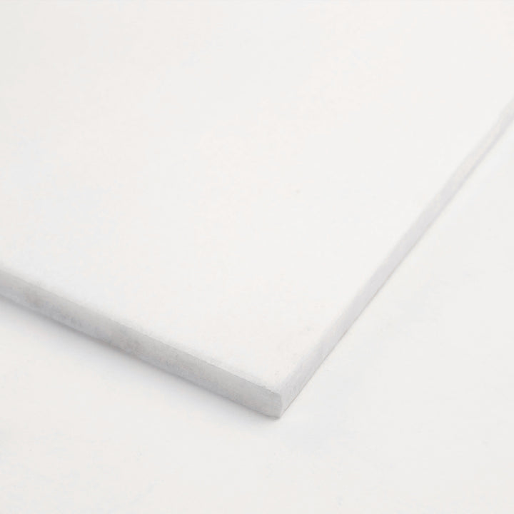 6x12 honed Thassos White marble tile captured in corner perspective, showcasing the balanced size, subtle matte sheen, and radiant white clarity.