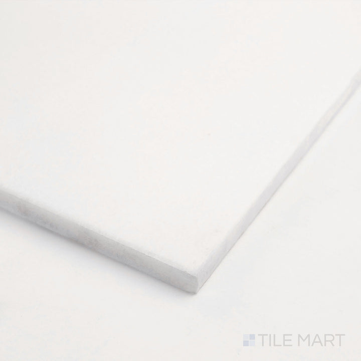 Corner close-up of Thassos White Marble 6x12 polished tile showing flawless white surface and sleek smooth edge.
