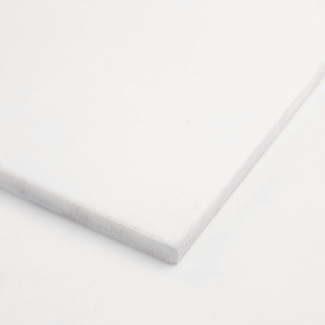 12x24 honed Thassos White marble tile viewed from the corner, emphasizing the elongated layout and soft honed finish of this brilliant white stone.