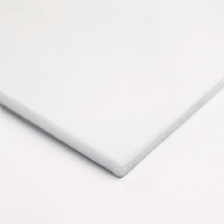 12x24 polished Thassos White marble tile shown corner-on, highlighting its mirrored finish and seamless white body for a sleek, modern aesthetic.