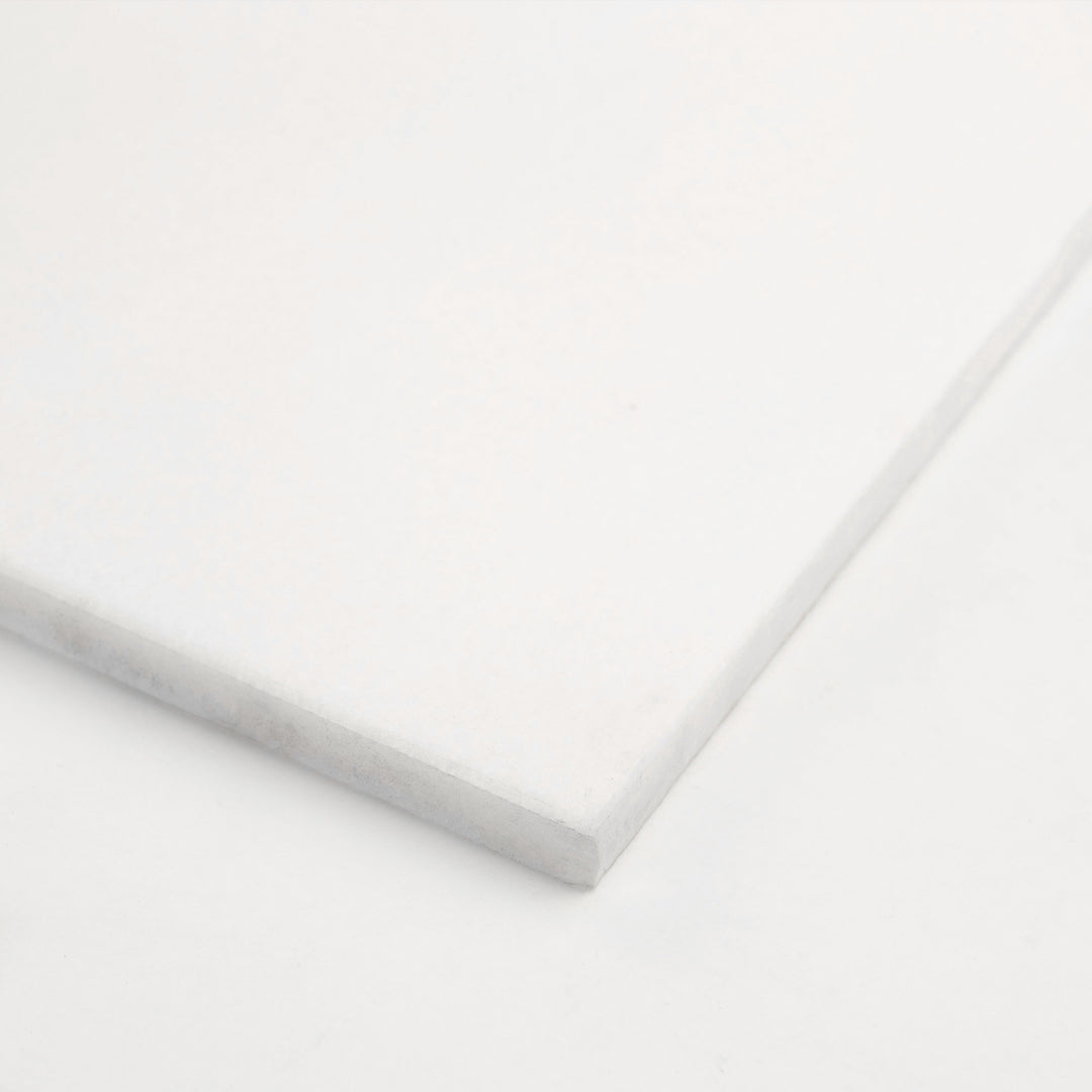 18x18 honed Thassos White marble tile angled to reveal its balanced proportion and matte texture, perfect for understated luxury.