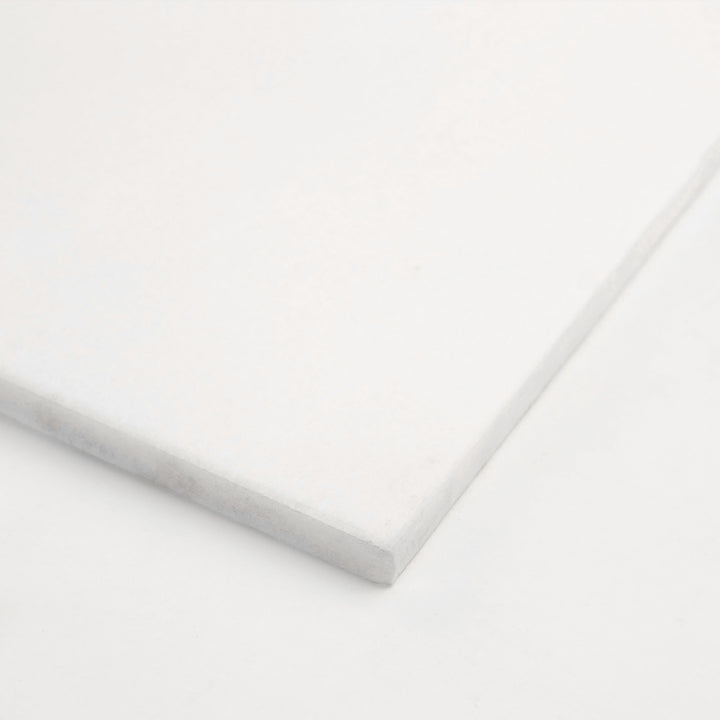 18x18 honed Thassos White marble tile angled to reveal its balanced proportion and matte texture, perfect for understated luxury.