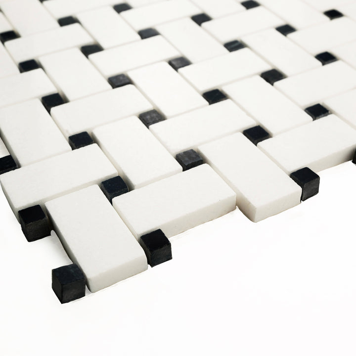 Thassos White marble basketweave mosaic with black dot, polished finish, viewed from the corner to emphasize the glossy surface and sharp contrast details.