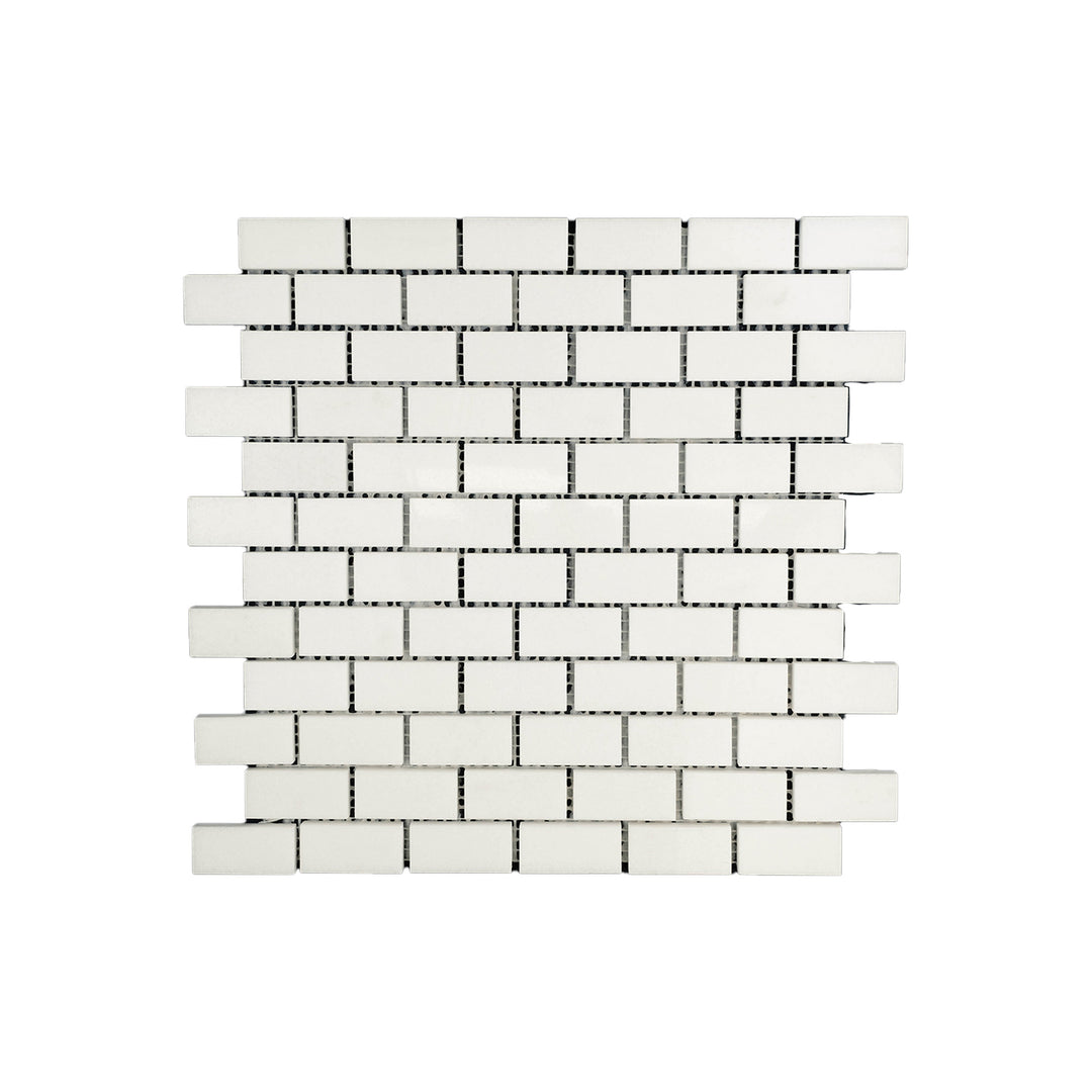 Polished 1x2 brick mosaic in Thassos White Marble seen from above, offering reflective surfaces and clean edges in a timeless brick layout.