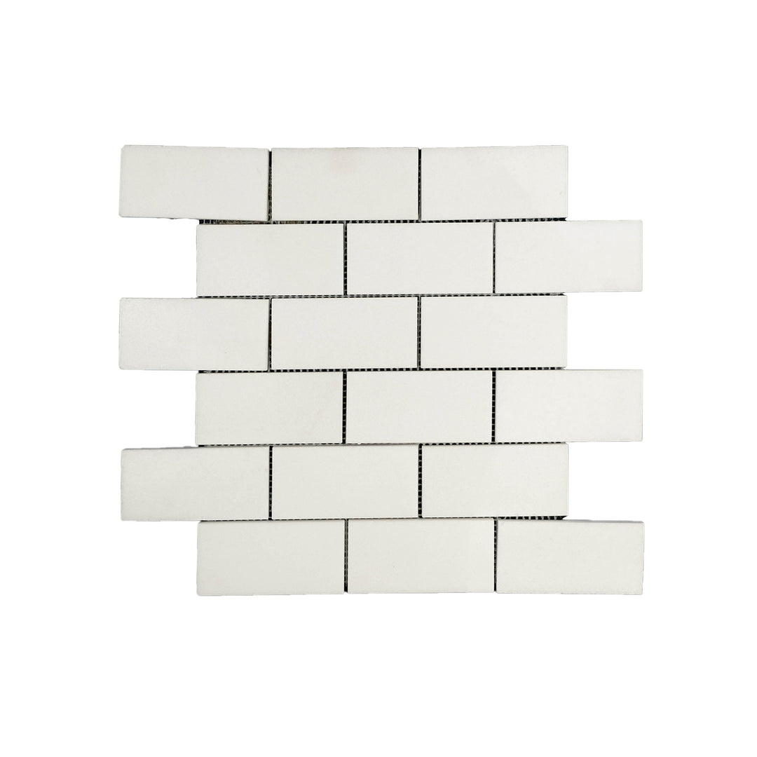 Top-down shot of Thassos White Marble 2x4 polished brick mosaic, combining clean rectangular styling with high-gloss marble elegance.