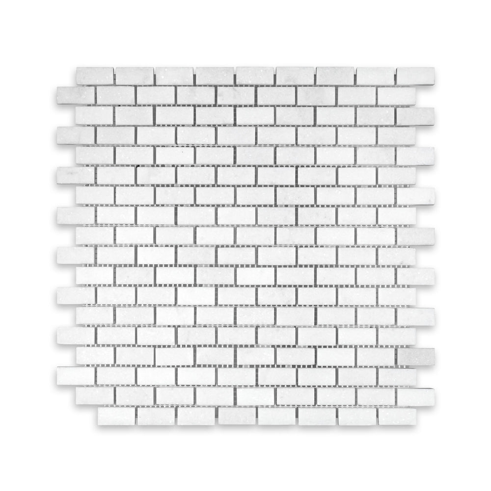 Thassos White Marble 5/8 by 1-1/4 brick mosaic in honed finish shown from above, offering small-scale layout with refined matte surface and bright tone.
