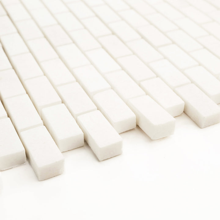 5/8 x 1-1/4 brick honed mosaic in Thassos White marble, angled perspective shows off fine detail and soft surface texture.