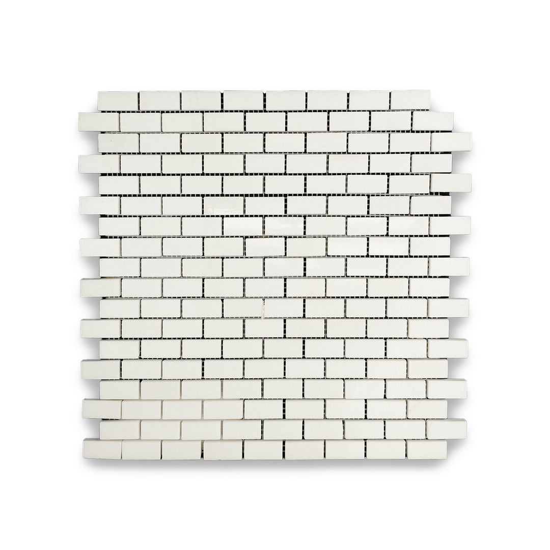 Overview of Thassos White Marble 5/8x1-1/4 Brick Polished Mosaic with finely cut white marble tiles and a glossy texture.