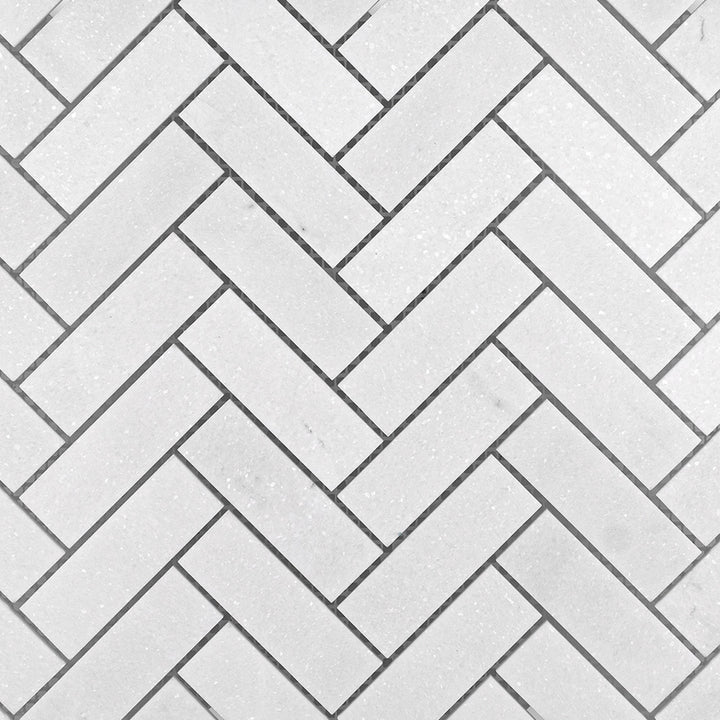 Clean view of Thassos White Marble 1x3 Herringbone Honed Mosaic with elongated matte tiles arranged in a traditional herringbone pattern.