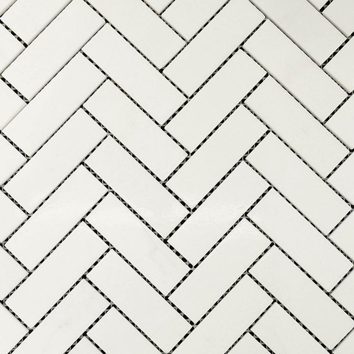 Surface view of Thassos White Marble 1x3 Herringbone Polished Mosaic displaying polished rectangular marble in a refined layout.