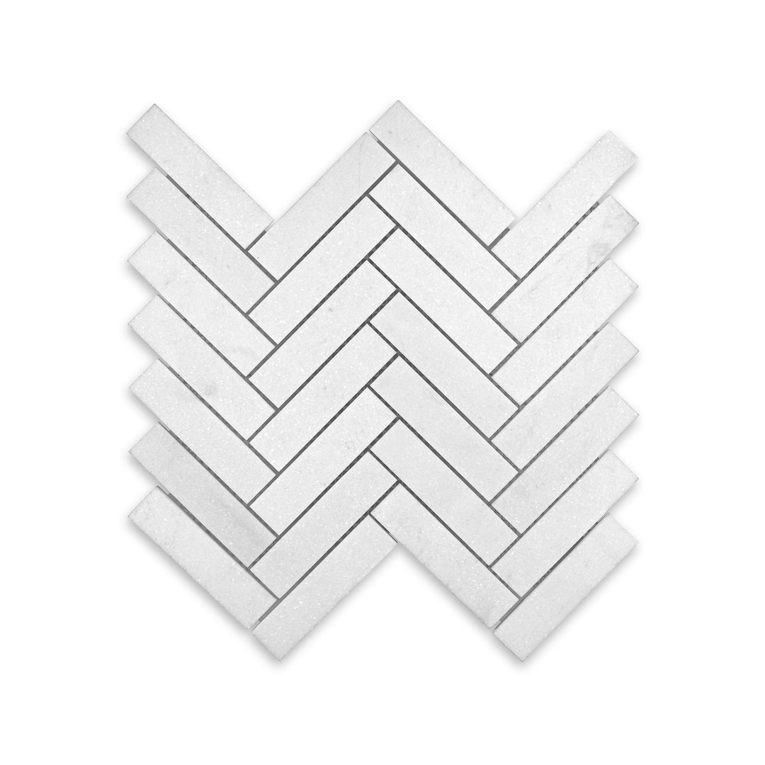 Top-down shot of Thassos White Marble 1x4 herringbone mosaic in honed finish, featuring elongated tile pieces with a subtle matte texture.