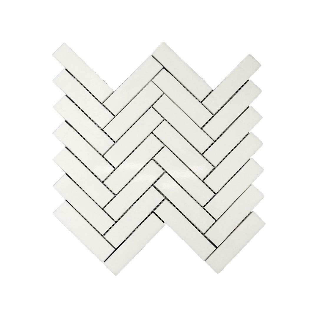 Polished Thassos White Marble 1x4 herringbone mosaic captured from above, showcasing bright white marble with sleek lines and elegant patterning.