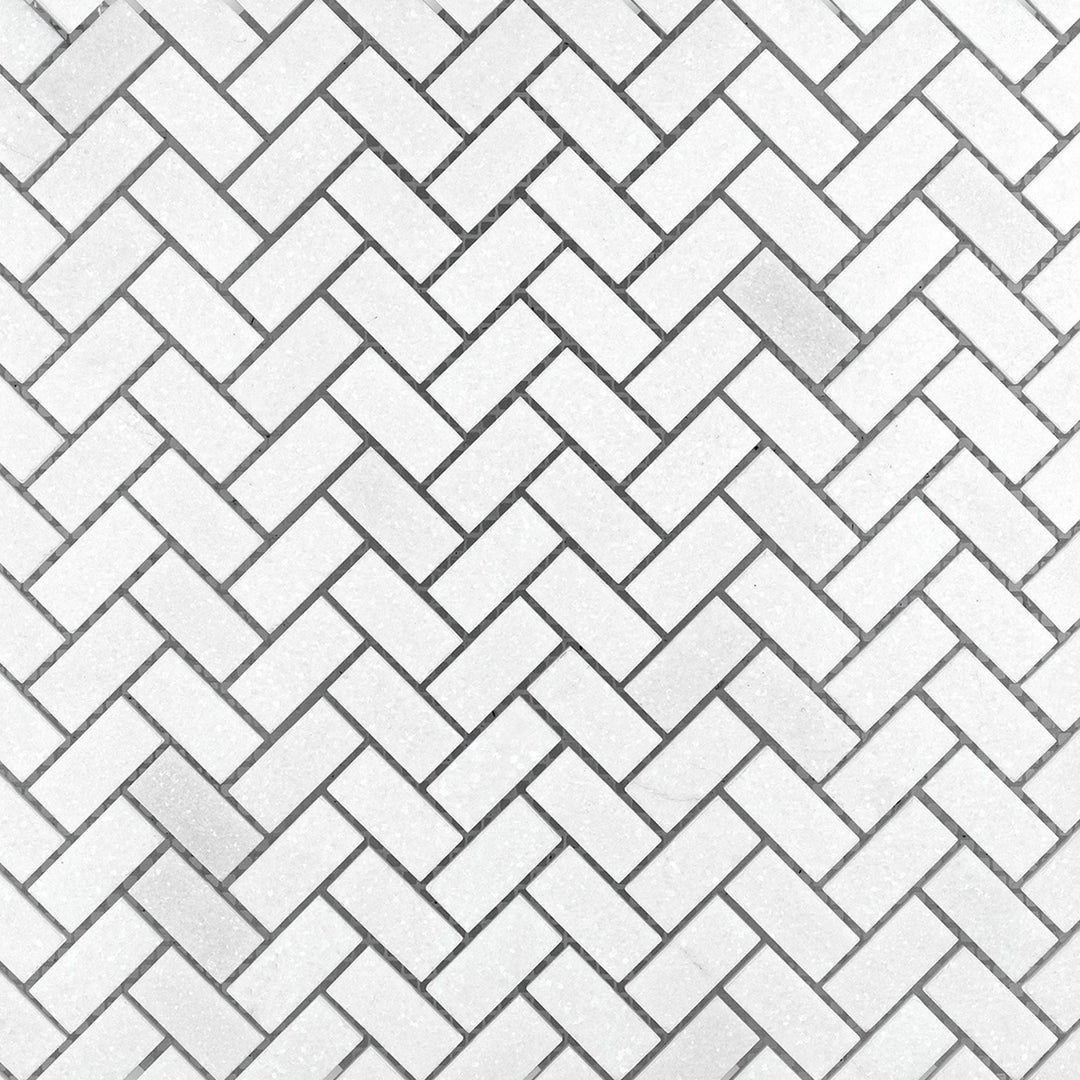 Surface view of Thassos White Marble 5/8x1-1/4 Herringbone Honed Mosaic showing compact honed marble pieces in a tight herringbone formation.