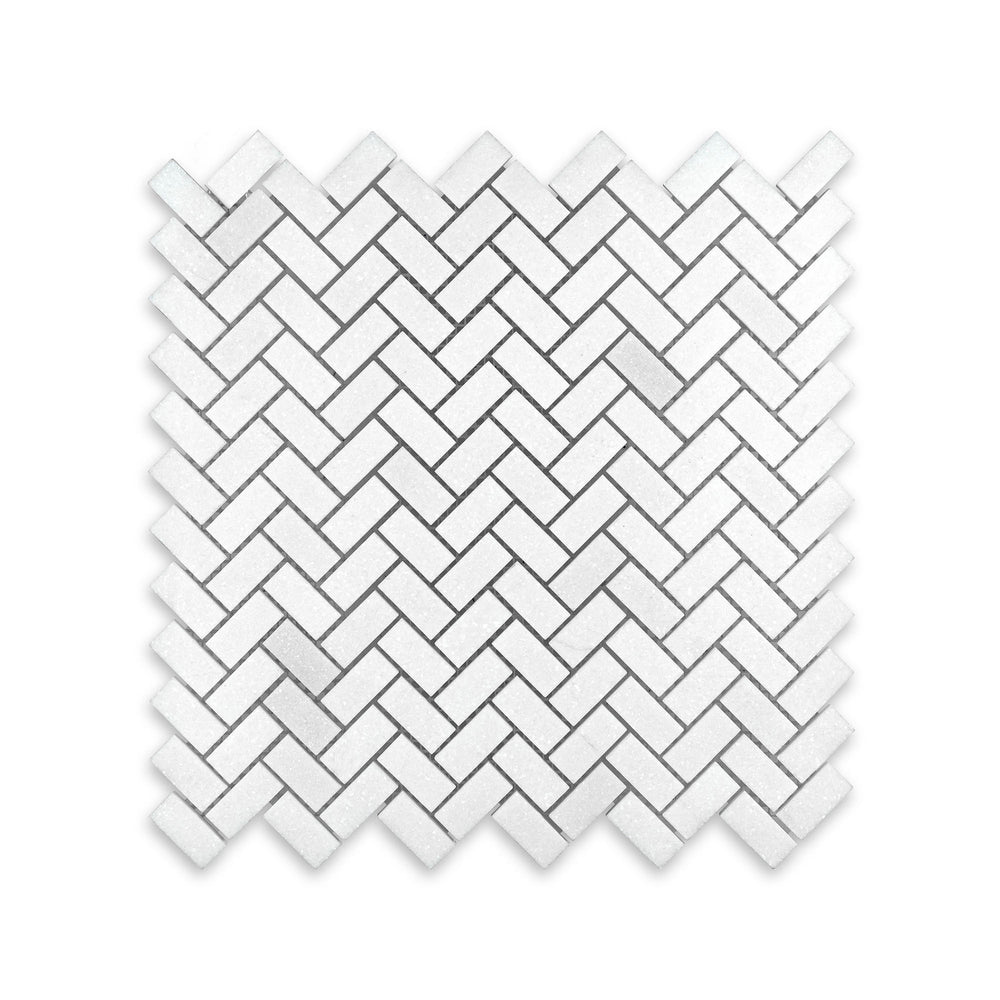 Overhead view of Thassos White Marble 5/8 by 1-1/4 herringbone mosaic in honed finish, featuring a compact diagonal layout with smooth white tones.