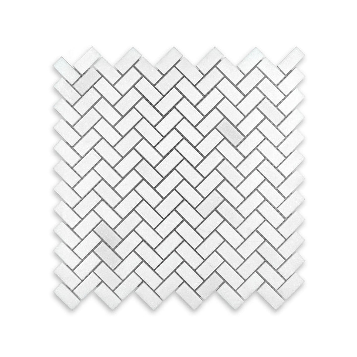 Overhead view of Thassos White Marble 5/8 by 1-1/4 herringbone mosaic in honed finish, featuring a compact diagonal layout with smooth white tones.