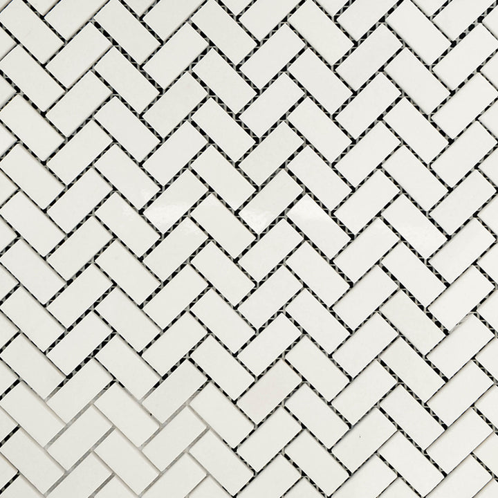 Clean view of Thassos White Marble 5/8x1-1/4 Herringbone Polished Mosaic showcasing polished mini tiles in a sharp, elegant herringbone pattern.