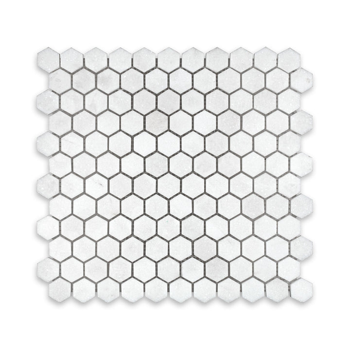 Top-down image of Thassos White Marble 1 inch hexagon mosaic in honed finish, presenting a classic honeycomb layout with soft white matte texture.