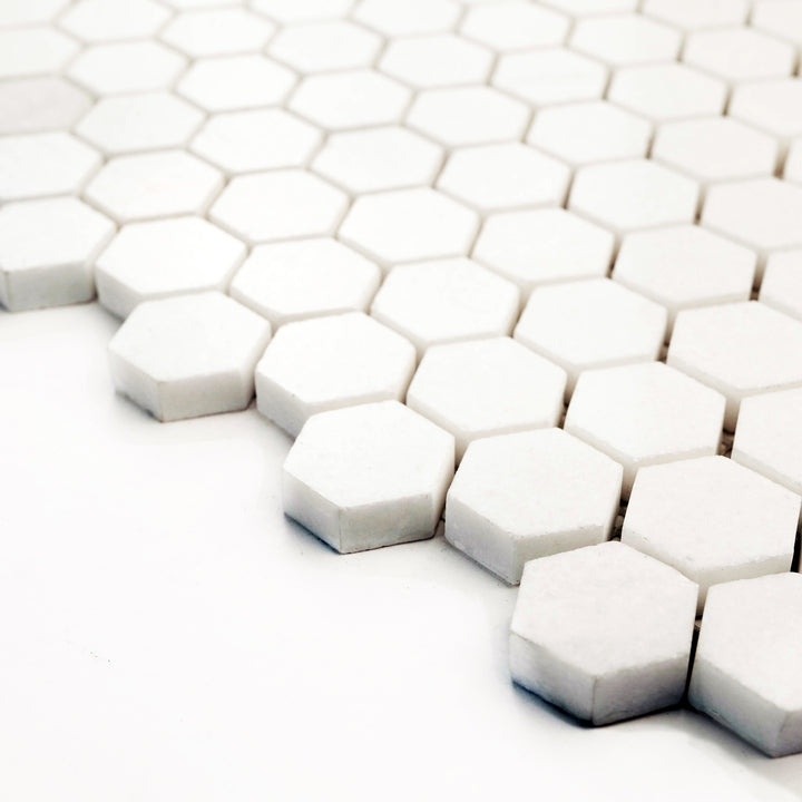 Thassos White marble 1" hexagon mosaic, polished finish, corner presentation reveals brilliant reflectivity and geometric symmetry.
