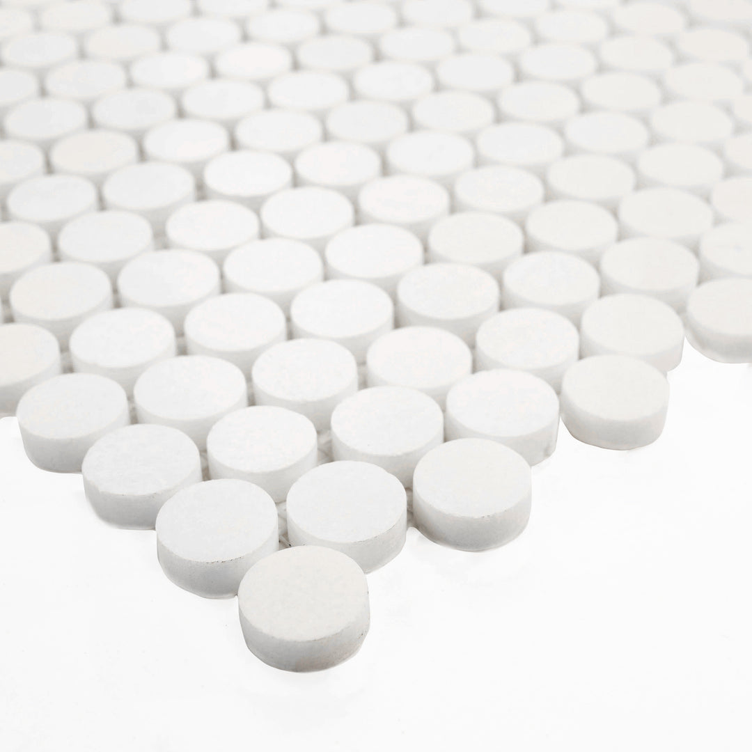 Corner angle of Thassos White Marble Penny Round Polished Mosaic Tile, reflecting a smooth, glossy finish and elegant circular design ideal for luxurious surfaces.