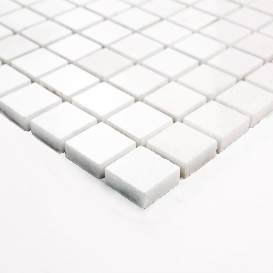 Thassos White Marble 1-Inch Square Honed Mosaic Tile shown from a corner, offering a subtle matte texture and clean grid pattern perfect for refined backsplash and wall accents.