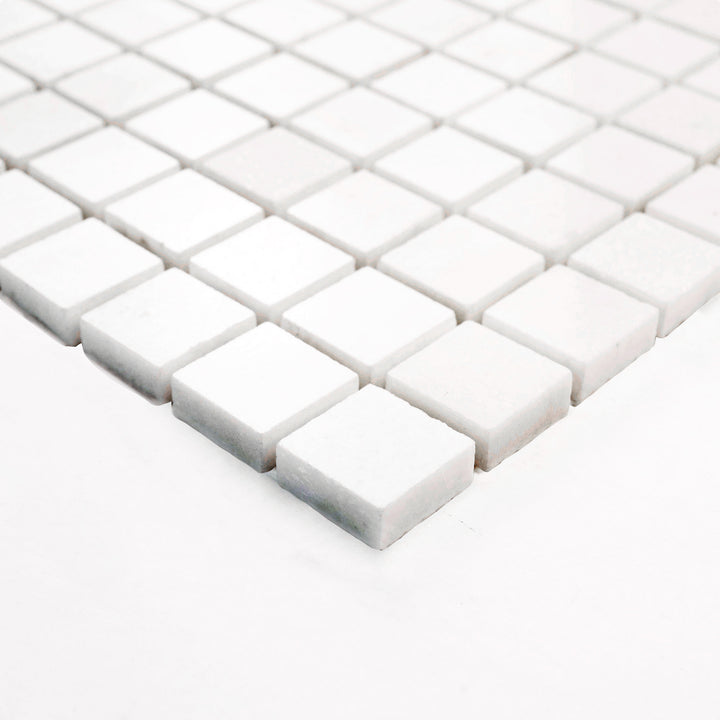 Thassos White Marble 1-Inch Square Honed Mosaic Tile shown from a corner, offering a subtle matte texture and clean grid pattern perfect for refined backsplash and wall accents.