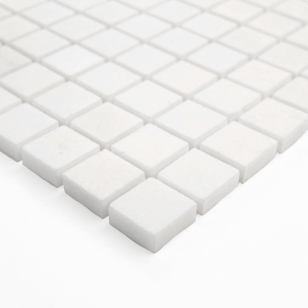 Polished Thassos White Marble 1-Inch Square Mosaic Tile viewed from the corner, illustrating the pristine white surface and modern symmetry suited for upscale interiors.