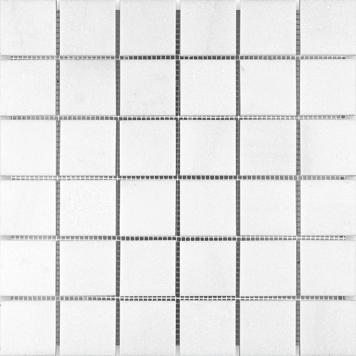 Overview of Thassos White Marble 2" Square Honed Mosaic presenting larger matte squares in a balanced, minimalist composition.