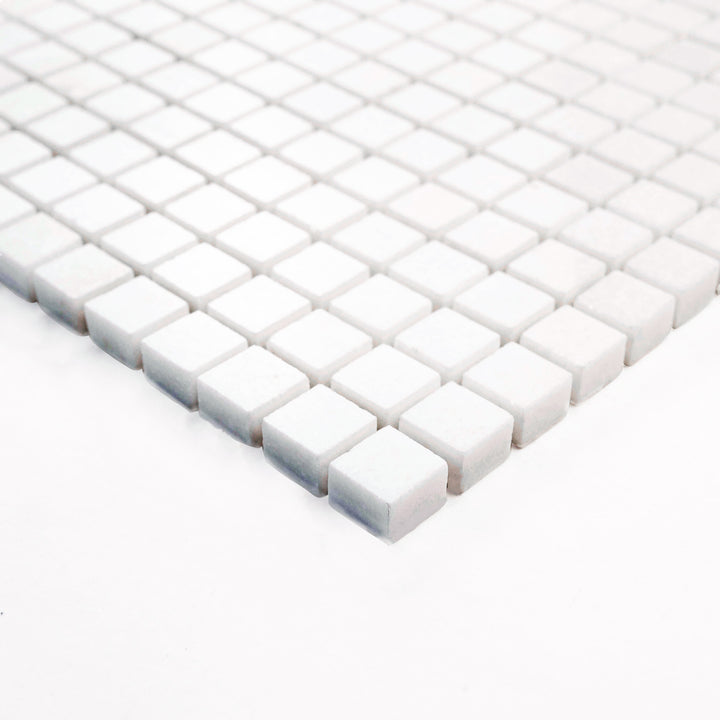 Thassos White Marble 5/8-Inch Square Polished Mosaic Tile viewed at the corner, featuring a high-shine finish and miniature grid ideal for elegant feature walls and trims.