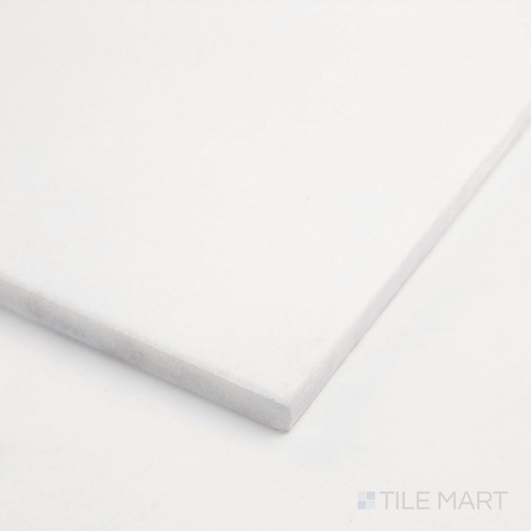 Corner close-up of Thassos White Marble 6x12 honed tile showing soft matte surface and clean bright texture.