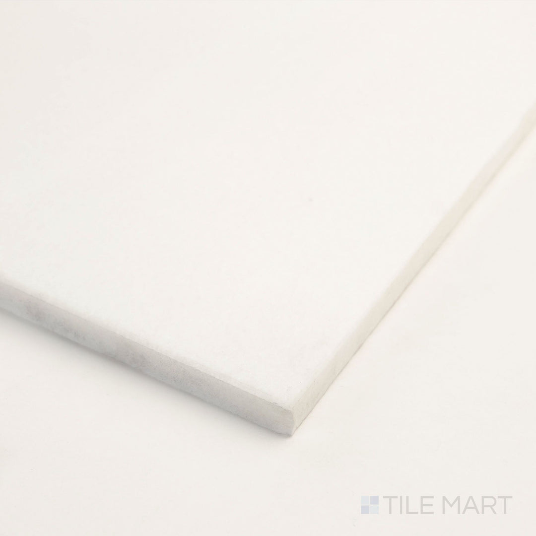 At the corner, the Thassos White Marble 12x24 polished tile highlights its reflective finish and pristine surface.