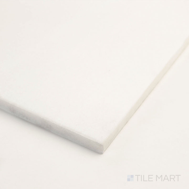 At the corner, the Thassos White Marble 12x24 polished tile highlights its reflective finish and pristine surface.