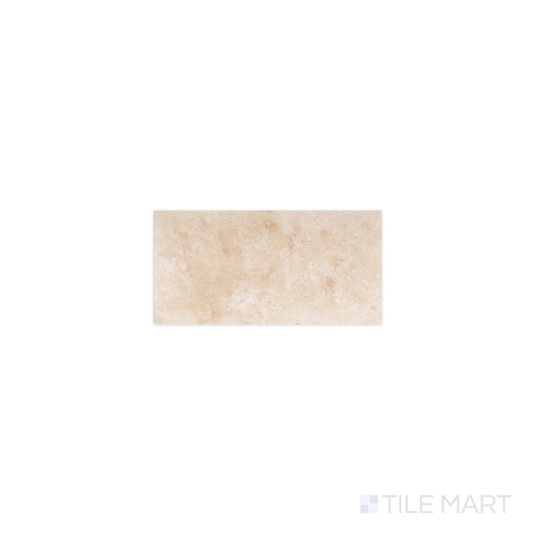 Flat-lay of Ivory Premium Travertine 3x6 filled and honed tile, a creamy beige stone with subtle veining and a smooth matte surface.