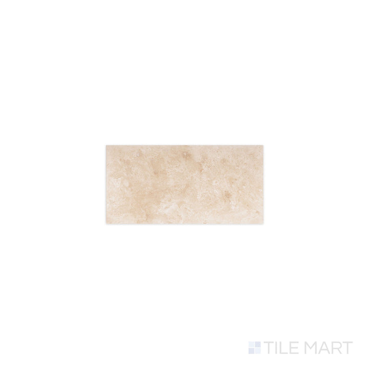 Flat-lay of Ivory Premium Travertine 3x6 filled and honed tile, a creamy beige stone with subtle veining and a smooth matte surface.