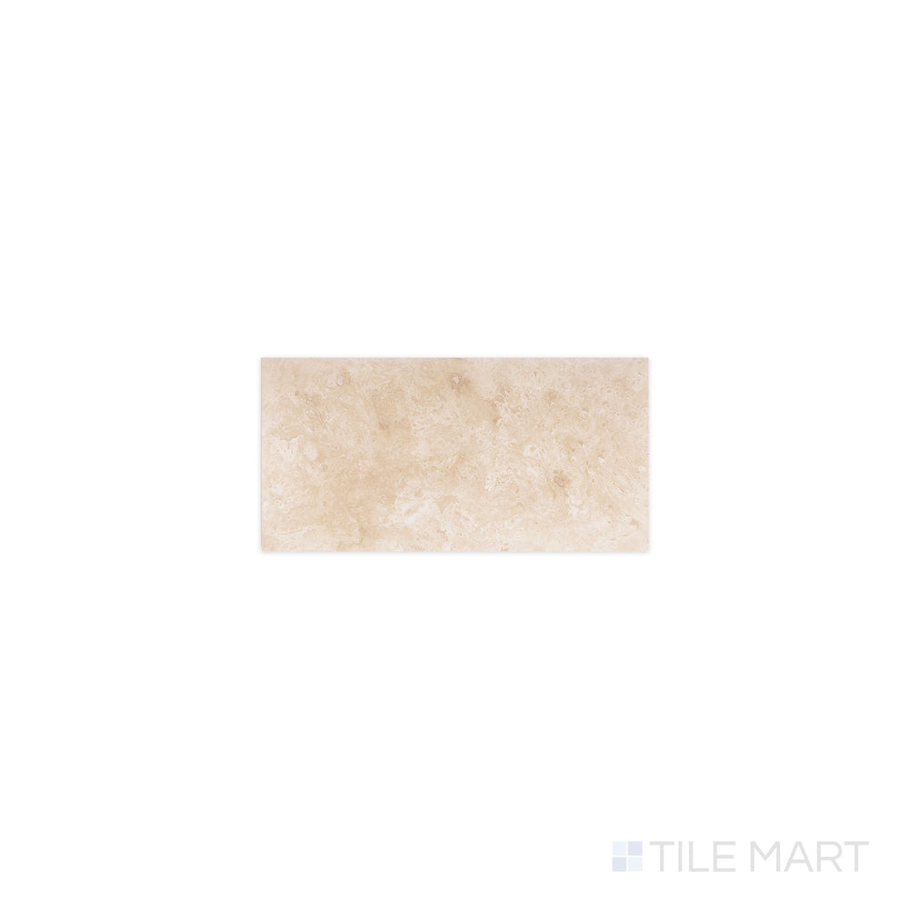 Flat-lay of Ivory Premium Travertine 3x6 filled and honed tile, a creamy beige stone with subtle veining and a smooth matte surface.