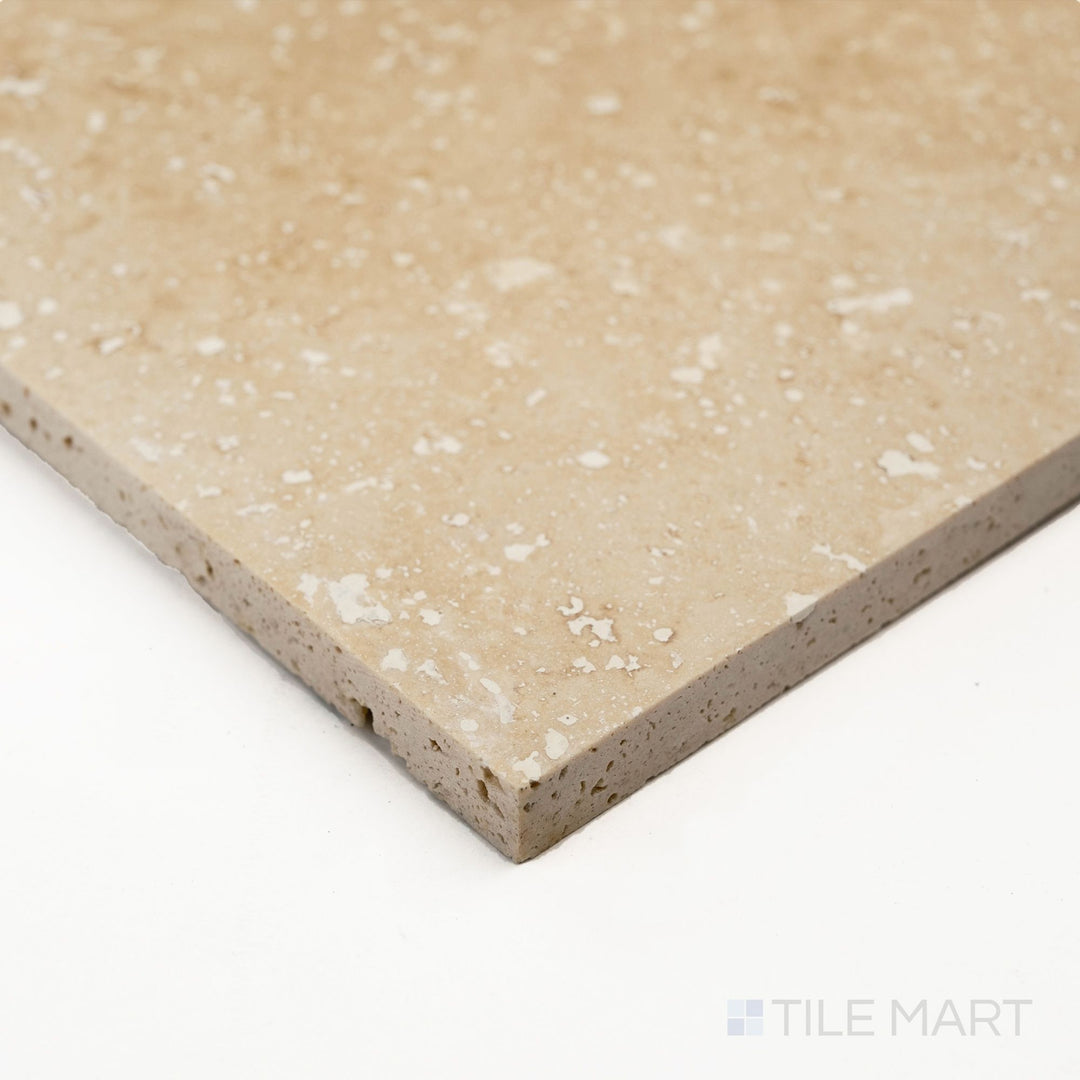 A detailed corner shot of Ivory Premium Travertine 3x6 filled and honed tile showing smooth matte texture and warm tone.
