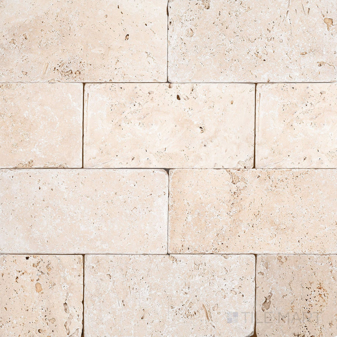 Surface view of Ivory Premium Travertine 3x6 Tumbled Tile showcasing warm ivory tones and a rustic, textured tumbled finish.