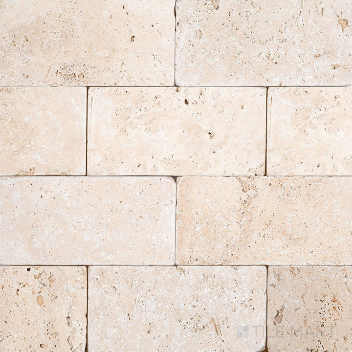 Surface view of Ivory Premium Travertine 3x6 Tumbled Tile showcasing warm ivory tones and a rustic, textured tumbled finish.