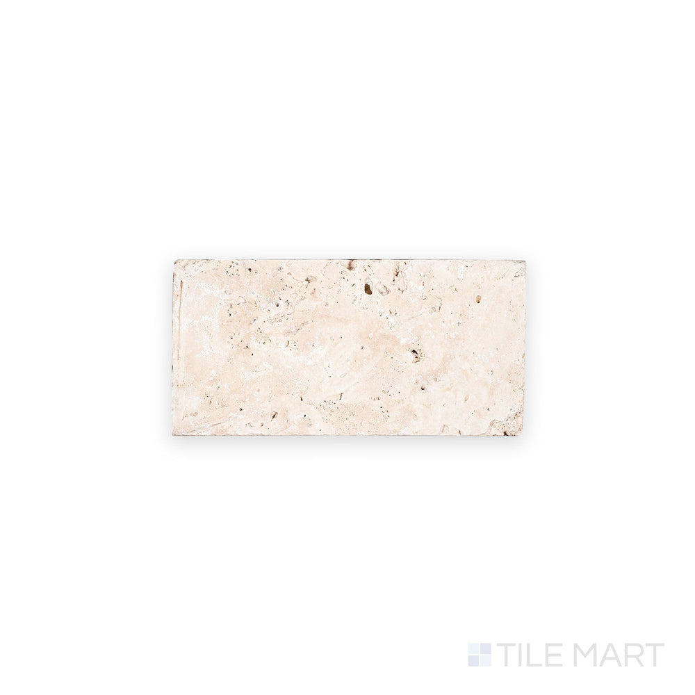 Top-down image of Ivory Premium Travertine 3x6 tile in tumbled finish, offering a rustic look with textured surface and natural beige tones.