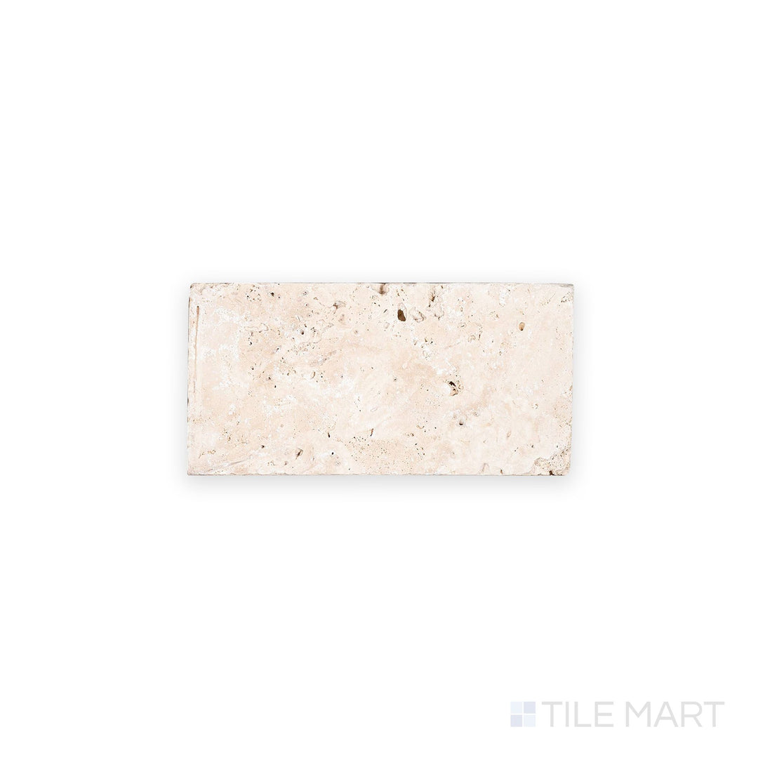 Top-down image of Ivory Premium Travertine 3x6 tile in tumbled finish, offering a rustic look with textured surface and natural beige tones.