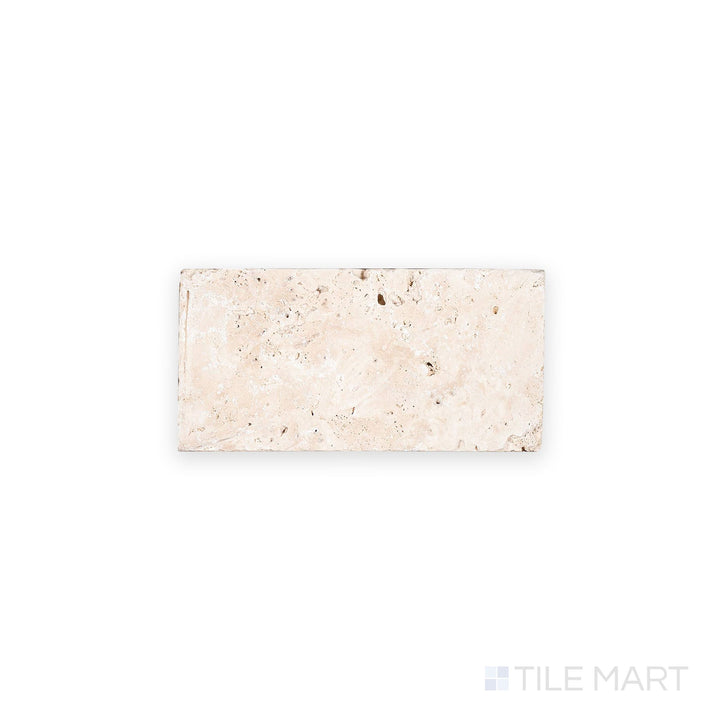 Top-down image of Ivory Premium Travertine 3x6 tile in tumbled finish, offering a rustic look with textured surface and natural beige tones.